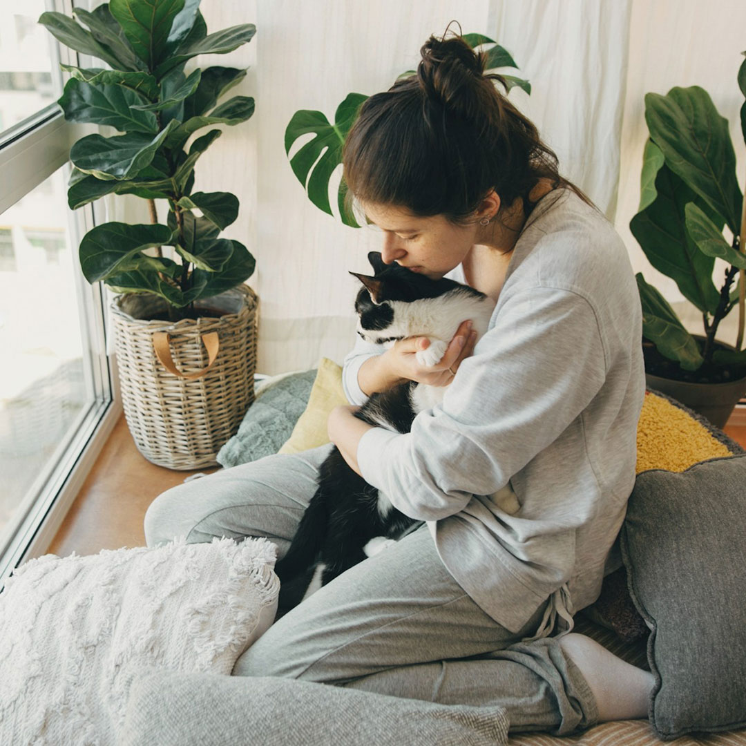 girl hugging cat